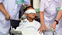  A -year-old Chinese boy whose eyes were gouged out by an attacker is receiving implants at a hospital in southern China after a Hong Kong eye doctor volunteered his service.